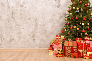decorated christmas tree in soft yellow lights with bokeh effect background. lofty apartment with tr