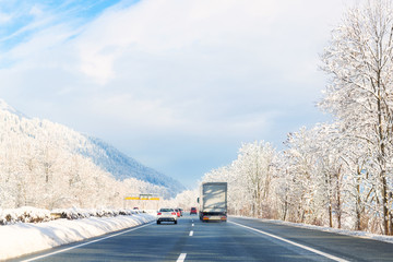 Winter alpine highway road landscape with beautiful white covered snow trees, mountains and blue sky on background at bright cold sunny day. Car trip travel journey. scenic austrian nature landscape