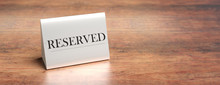 Reserved Table Tent On A Wooden Table, Copy Space. 3d Illustration