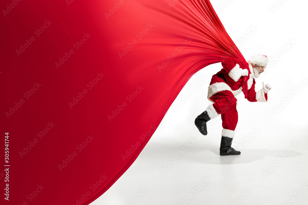 Santa Claus pulling huge bag full of christmas presents isolated on ...