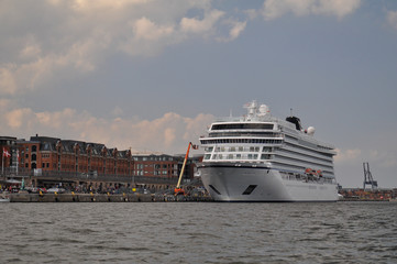 Copenhagen Denmark city port and cruise ship view during canal boat tour on cloudy day