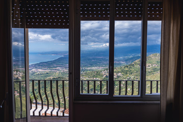 Wall Mural - Balcony of a hotel room wih a splendid view in Castelmola, small town on Sicily Island, Italy