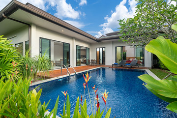 swimming pool and decking in garden of luxury home