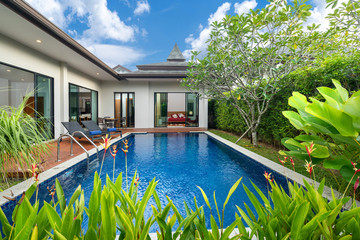 swimming pool and decking in garden of luxury home