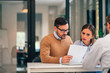 © bnenin - Serious couple studying contract agreement or health insurance in the office.