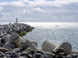 © Philip J Openshaw  - jetty and breakwater with lighthouse on the beach in funchal madeira with bright sunlit sea and sky