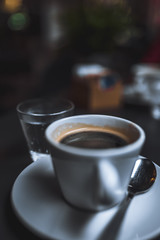 Americano in white cup on the dark background 