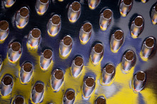 Closeup Shot Of Cheese Grater With Colorful Reflections