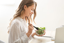 Woman Eating Healthy Vegetable Salad In Office