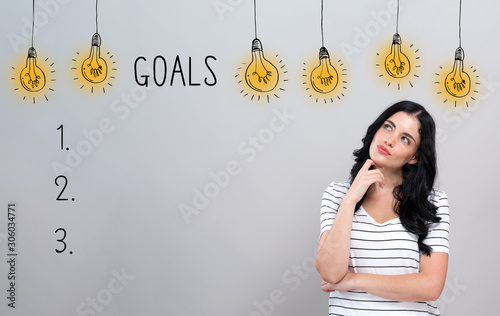 Fotomural Goal list with young woman in a thoughtful face