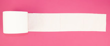 White Toilet Paper Roll On Pink Background