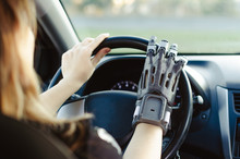A Man With A Prosthetic Arm Printed On A 3D Printer Drives A Car.