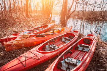 Group of canoes rental kayak on the lake shore beach