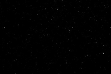 white bokeh on a black background. light spots texture. falling snow. star sky.