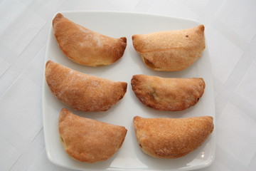 Wall Mural - Chicken pies in a white plate on the table, top view 