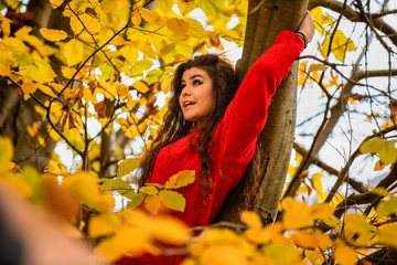 Portrait of a beautiful hispanic young woman in an autumnal forest