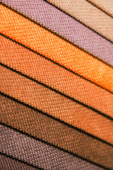 Wall Mural - Colorful and bright fabric samples of furniture and clothing upholstery. Close-up of a palette of textile abstract stripes of different colors