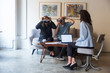 © Mangostar - Middle aged customers using VR glasses in interior designer office. People using virtual reality technology at home. VR presentation watching concept