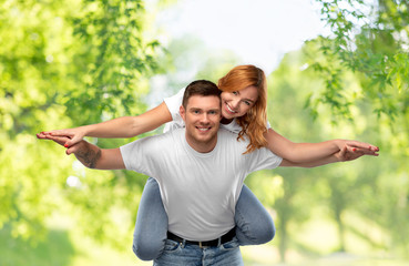 Poster - relationships and people concept - portrait of happy couple in white t-shirts having fun over green natural background