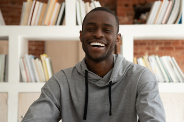 Head shot happy african american guy holding video call.