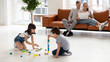 © fizkes - Young family have fun relax in living room together