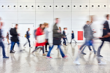 Many anonymous people go shopping in the mall