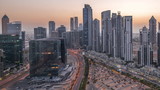 Fototapeta Paryż - Modern residential and office complex with many towers aerial day to night timelapse at Business Bay, Dubai, UAE.