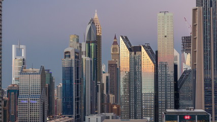  Aerial view of new skyscrapers and tall buildings in Dubai day to night timelapse