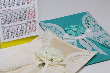 Wall Mural - Handmade greeting cards made of paper. Decorated with braid flowers. Nearby is a fragment of the calendar with the month of December.