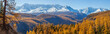 Panoramic autumn view, sunny day, snow-capped peaks.