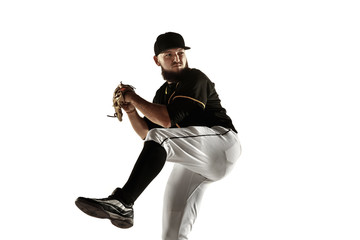 Baseball player, pitcher in a black uniform practicing and training isolated on a white background. Young professional sportsman in action and motion. Healthy lifestyle, sport, movement concept.