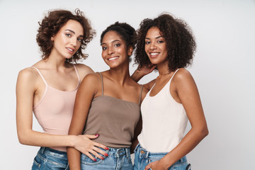 Wall Mural - portrait of three seductive multiethnic women standing together and smiling