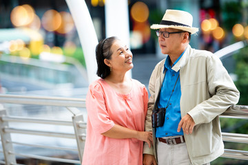 elderly travel and tourism concept. asian senior couple traveling happy excited tourists at the city