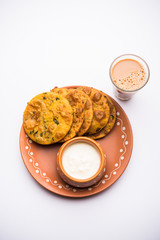 Canvas Print - Methi Poori or Puri made using Fresh fenugreek leaves missed with wheat flour, by making small pancake size shapes deep fried in oil, served with tea