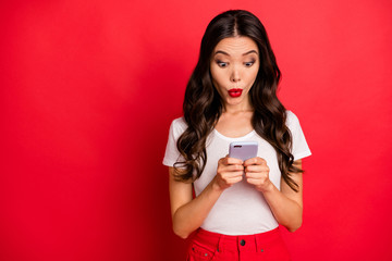 Wall Mural - Close-up portrait of her she nice gorgeous attractive lovely cheerful amazed funky wavy-haired girl using 5g app reading news repost isolated over bright vivid shine vibrant red color background