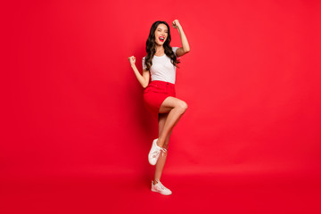 Wall Mural - Full length body size view of nice glamorous gorgeous attractive lovely cheerful cheery ecstatic wavy-haired girl celebrating accomplish isolated over bright vivid shine vibrant red color background