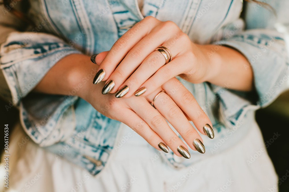 Fotografering Stylish trendy female mirror manicure, metal nail art