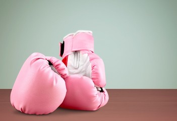 Wall Mural - Pink boxing gloves on wooden desk