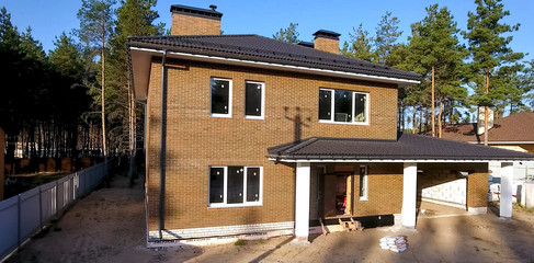 Bituminous tile for a roof. House with a roof from a bituminous tile. a roof from a bituminous tile. Moder