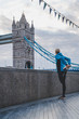 Athlete warm up before morning Run in london. Tower bridge in background