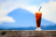 Ice Coffee with mountain background & blue sky