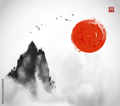 Ink wash painting with big red sun, flock of birds and high misty mountain pe...