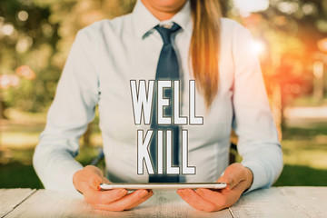 Poster - Writing note showing Well Kill. Business concept for operation of placing a column of heavy fluid into a well bore Female business person sitting by table and holding mobile phone