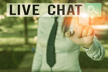 Writing note showing Live Chat. Business concept for talking with friend or someone through internet and PC phone Handsome business girl pointing with finger into empty space