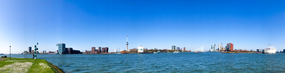 panoramic picture of rotterdam skyline at the port, blue sky