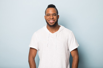 Wall Mural - Smiling happy African American man in glasses looking at camera