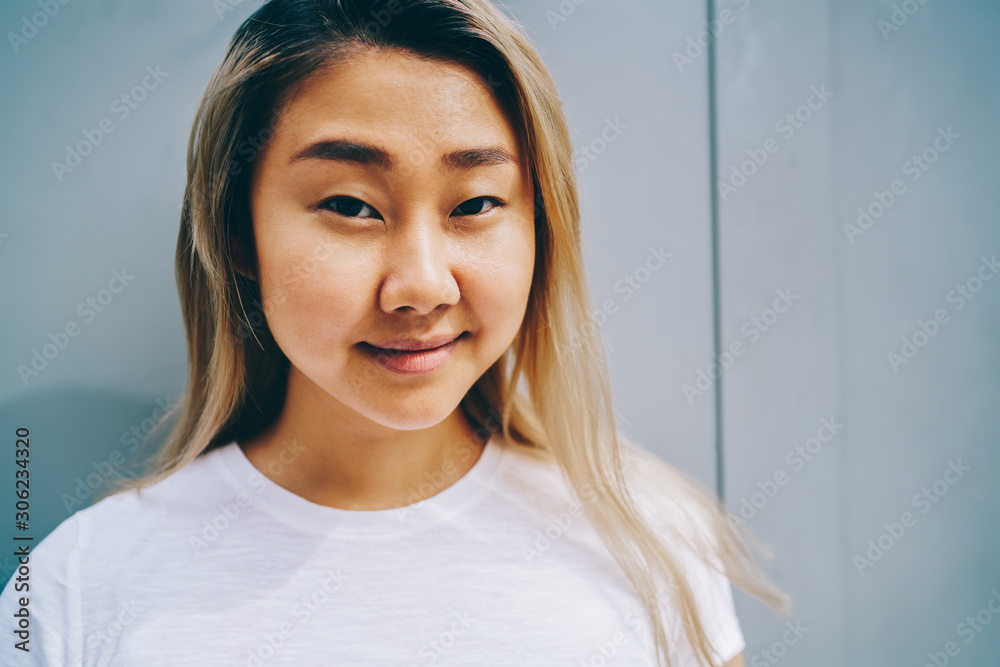 girl Half length portrait of cute chinese girl with clean skin posign near copy  space for advertising,