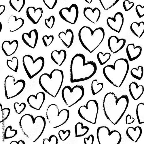 Romantic seamless pattern with cute images of hearts. Charcoal drawing on a w...