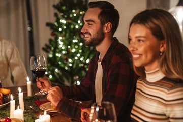 Wall Mural - Photo of beautiful cheerful people having Christmas dinner