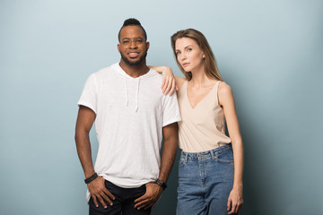 African American man and woman in casual clothes posing together